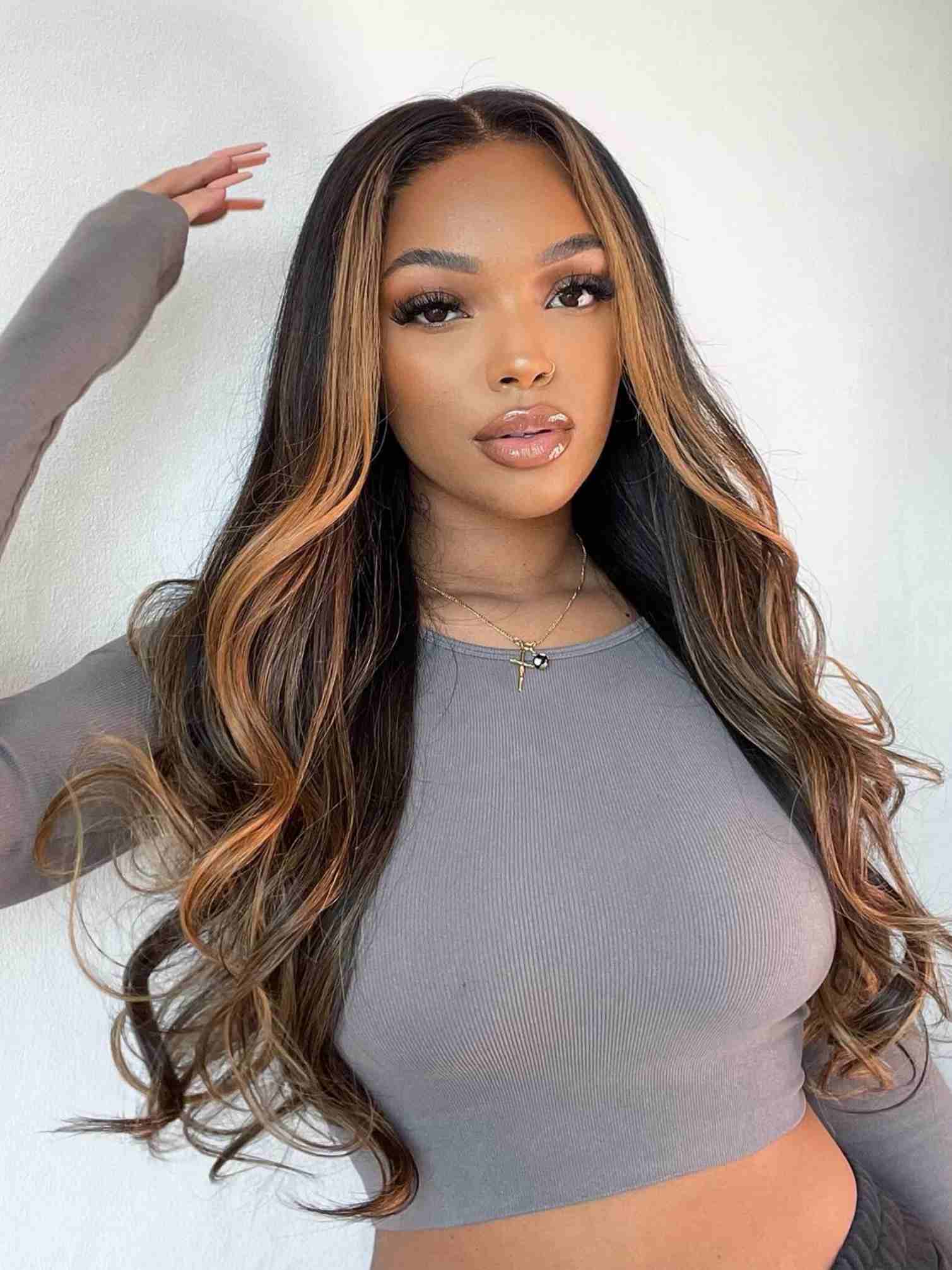 Model 2 front view wearing Angie HD lace wig – brown highlights and volume