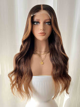 Front view of Charlotte brown wavy wig with blonde highlights on mannequin