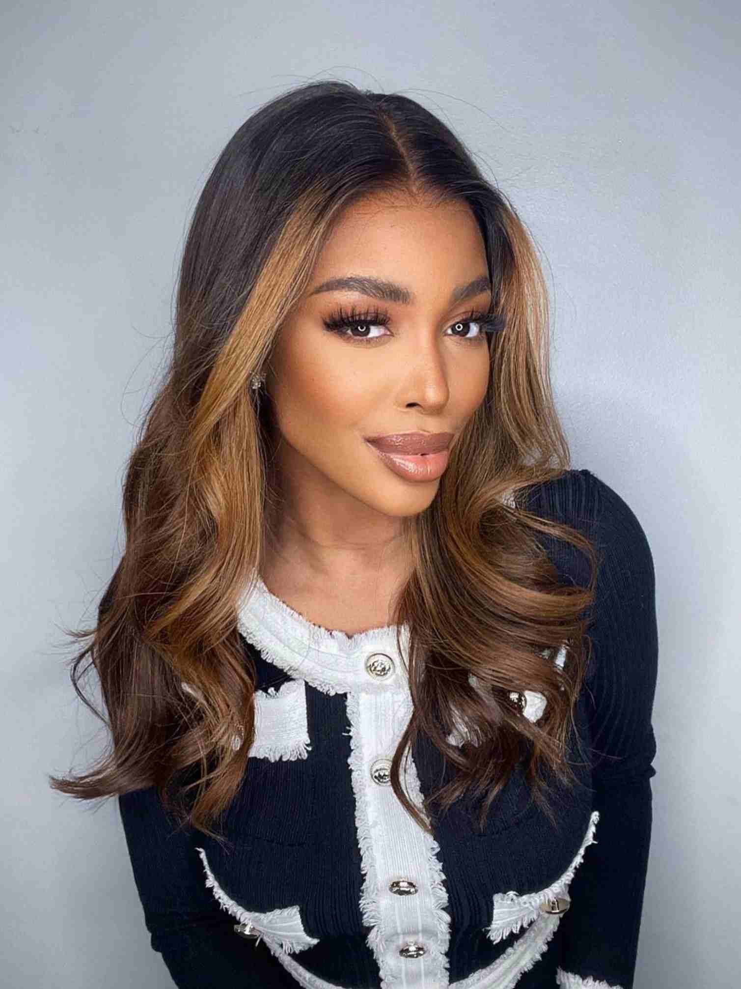 Model 1 wearing Angie Wig with brown highlights – front view, loose waves