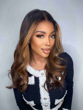 Model 1 wearing Angie Wig with brown highlights – front view, loose waves