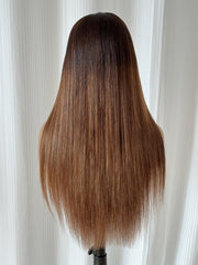 Back view of long ombre brown straight wig with sleek finish