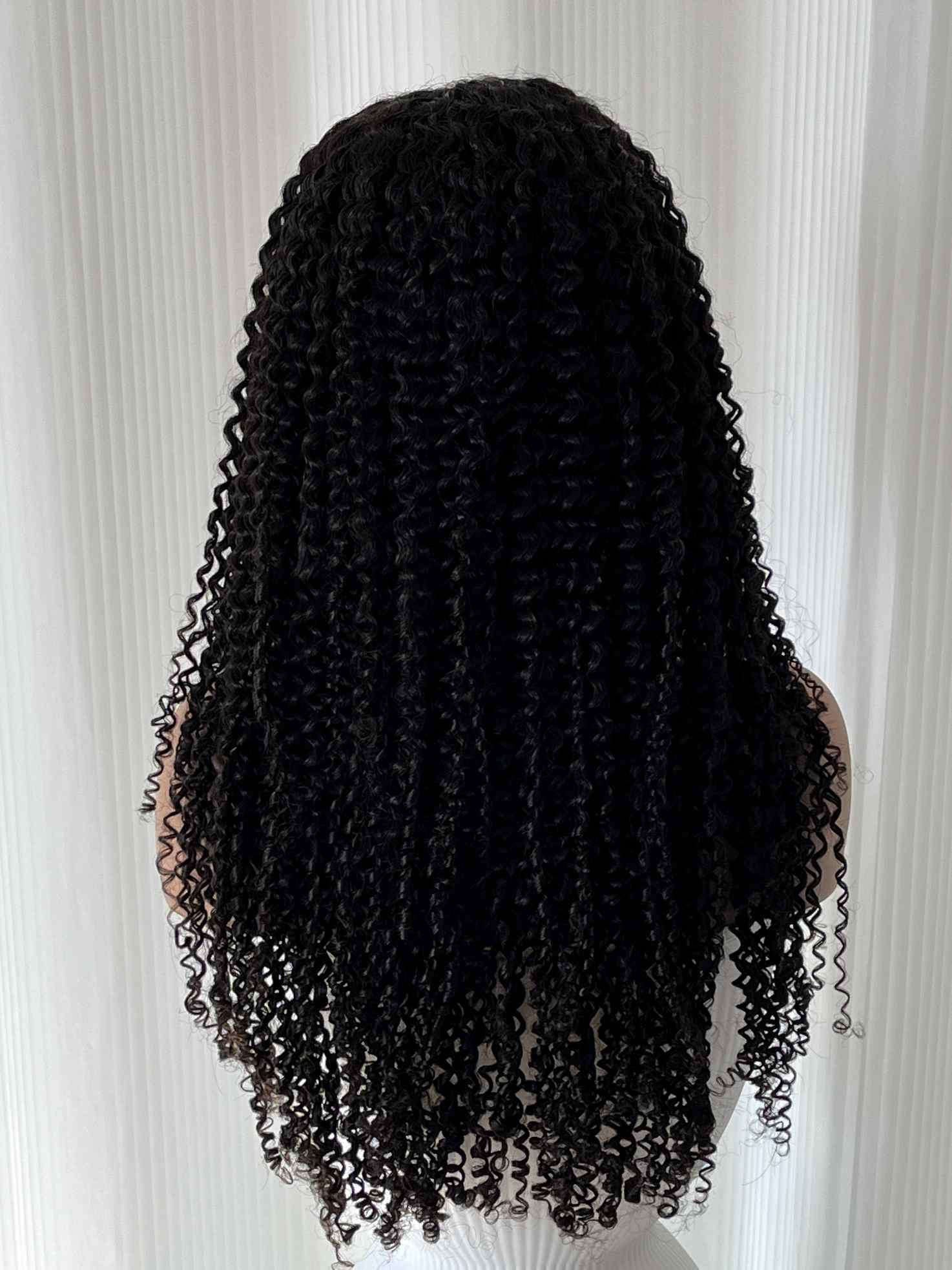 Back view of Doris human hair curly wig – breathable cap and defined curls