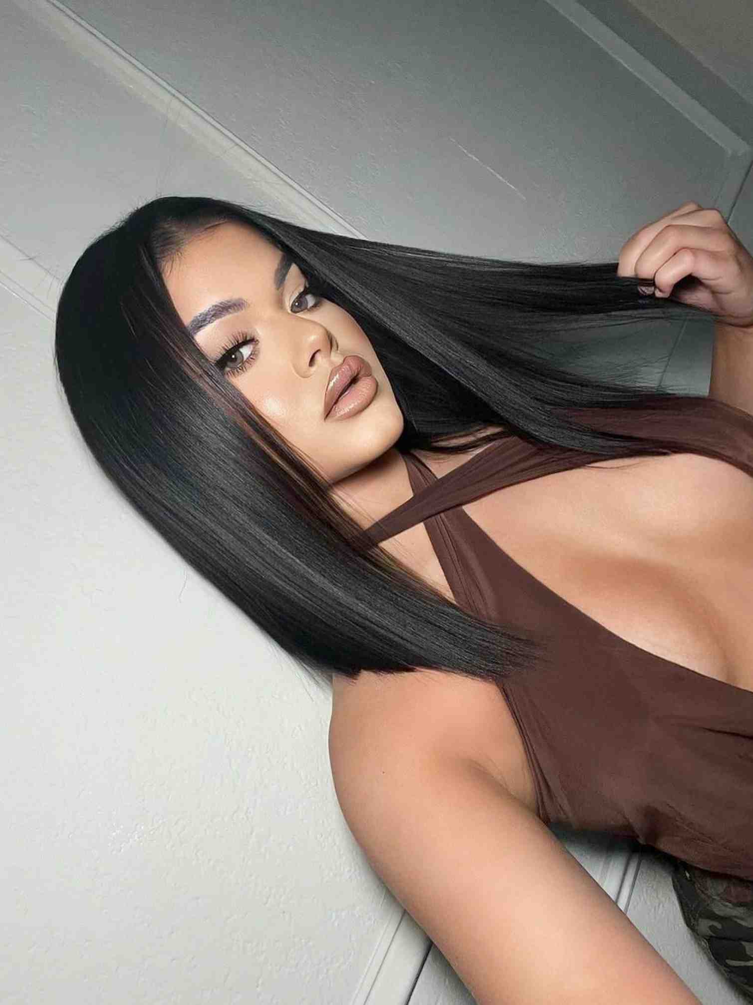 Model 1 side angle view wearing Alexis long bob wig – straight natural black