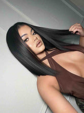 Model 1 side angle view wearing Alexis long bob wig – straight natural black