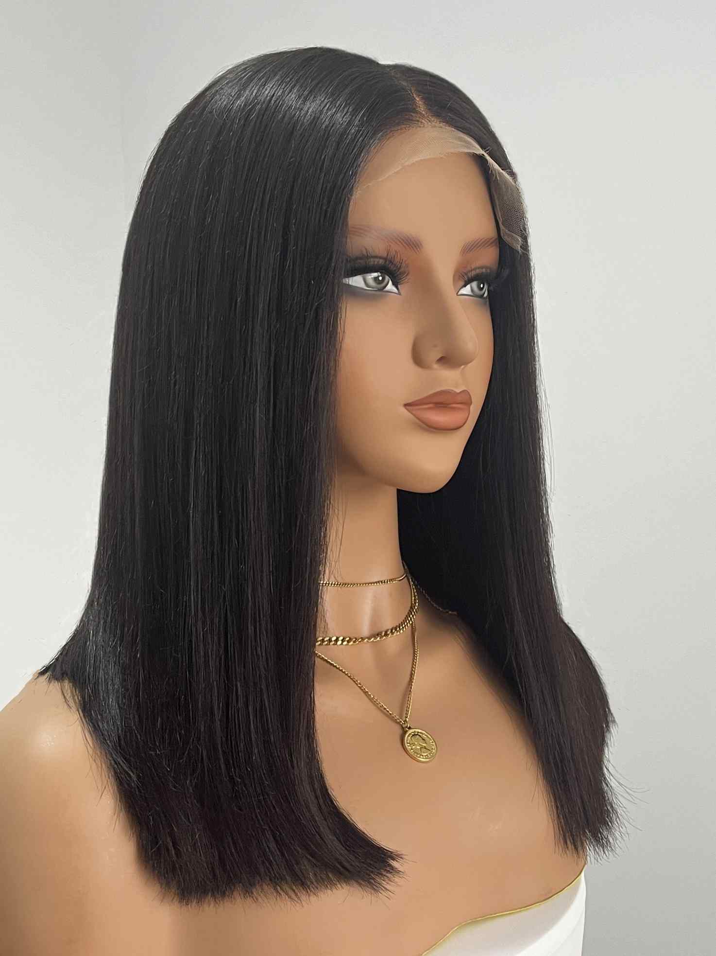 Side view of natural black 14” straight bob wig on mannequin