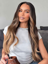 Front view of model wearing Selena chocolate brown to dark blonde highlight wavy human hair wig with HD lace, natural balayage look