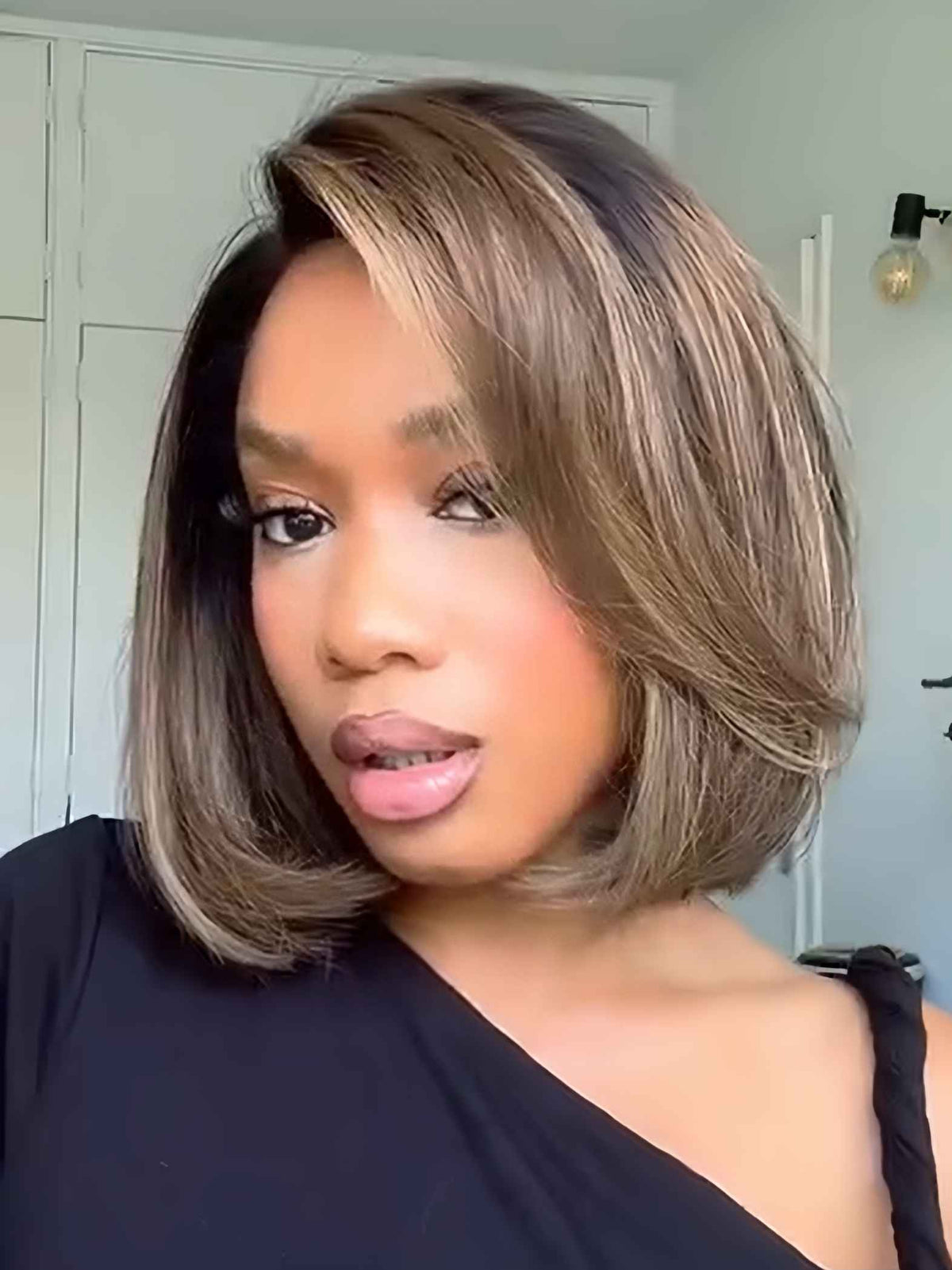 Aubrie 10 inch bob wig with brown blonde highlights worn by model, natural front view