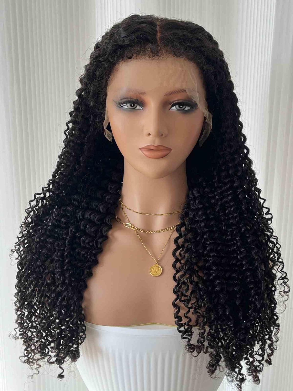 Front view of Doris curly wig on mannequin – glueless and pre-plucked